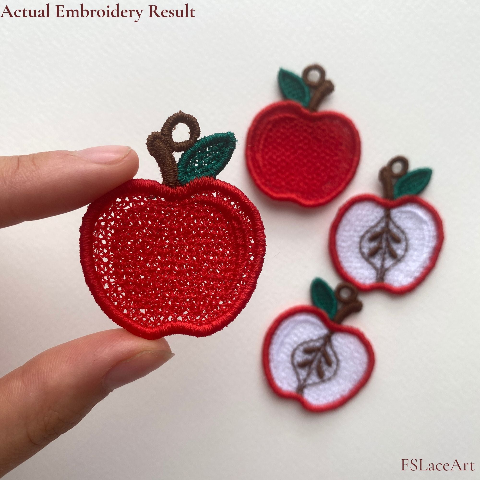 Actual sliced Apple FSL embroidery held in hand, with whole and sliced apple lace pieces in the background