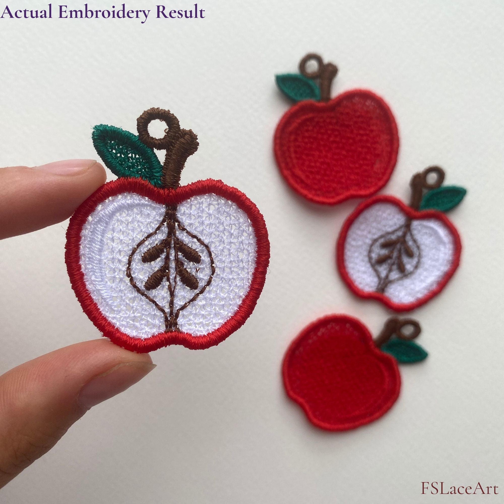 Actual whole red Apple FSL embroidery held in hand, with finished whole and sliced apple designs in the background