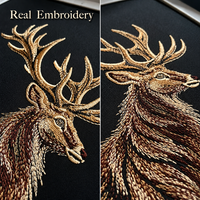 Two close-up views of actual stag embroidery on black fabric, showing the antlers, face and flowing fur stitches.