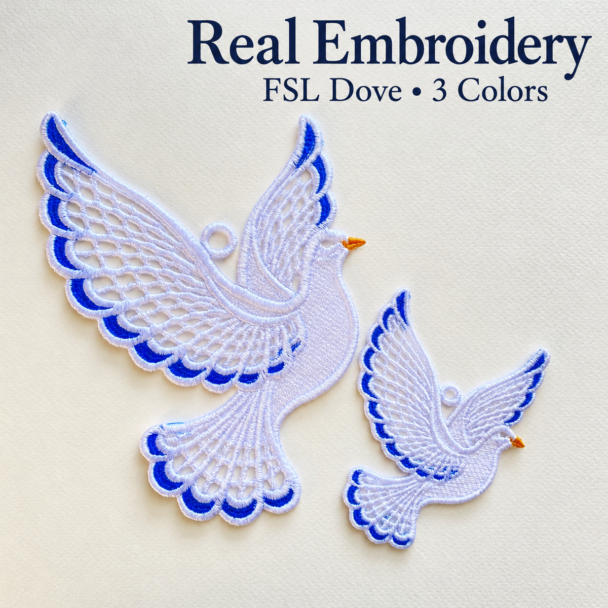 Two finished lace doves in different sizes on a cream background, with white openwork wings, blue accents and golden beaks.