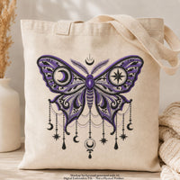 Cream canvas tote bag mockup with black and purple gothic moon moth embroidery, crescent moons and dangling star motifs.