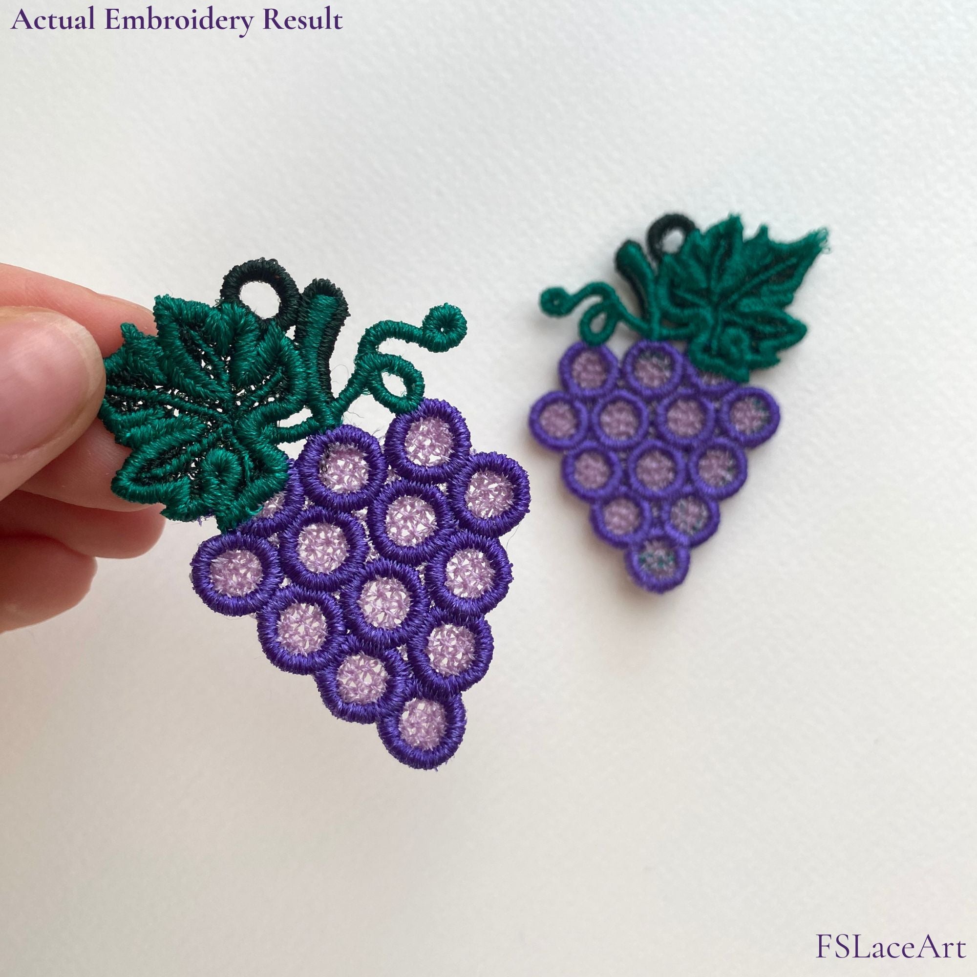 Actual purple Grape Cluster FSL embroidery held in hand with a second mirrored lace piece in the background
