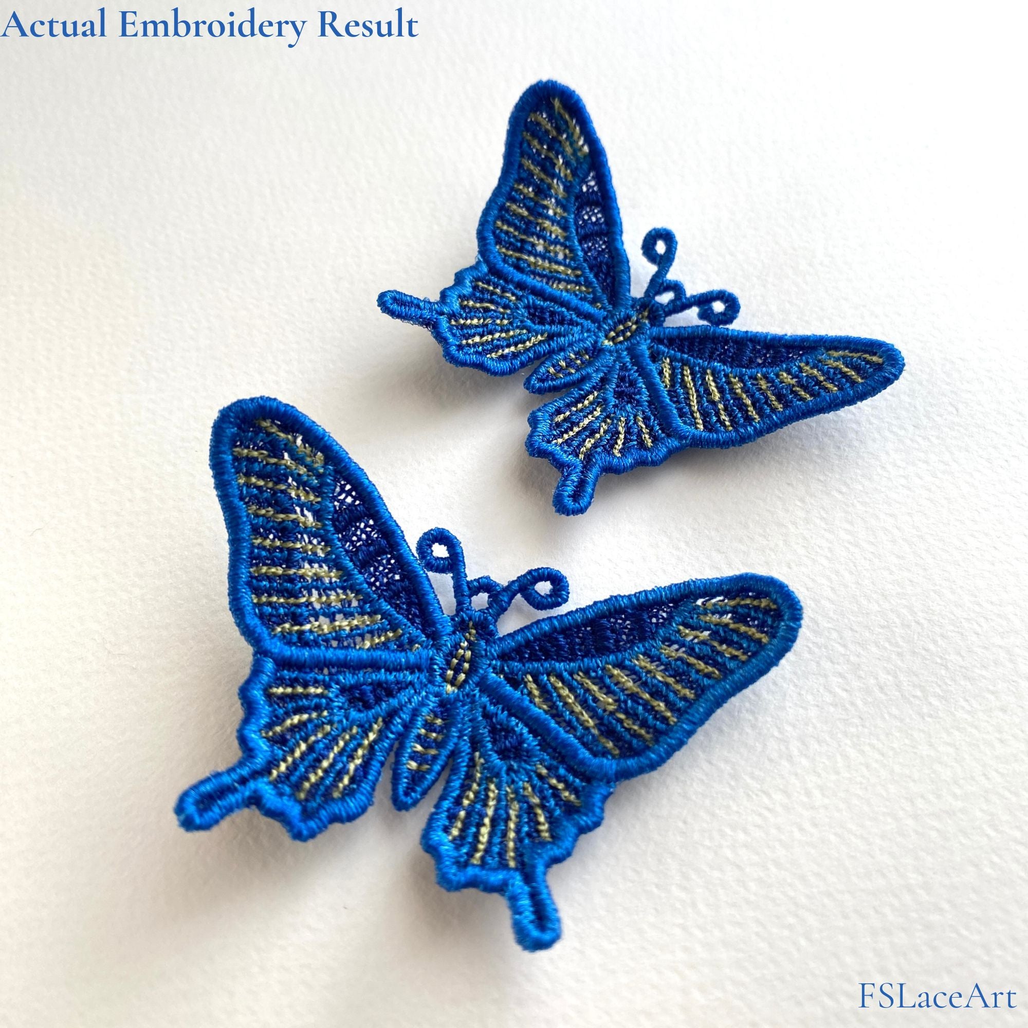 Two finished blue swallowtail butterfly FSL stitch-outs with raised wings and golden stripe details