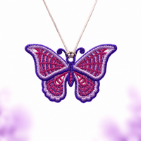 Purple and pink layered butterfly FSL pendant hanging from a light cord against a white background