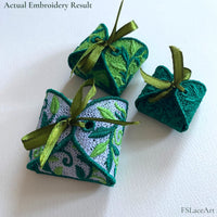 Three finished Leaf FSL gift boxes in white, light green and dark green thread with ribbon bows