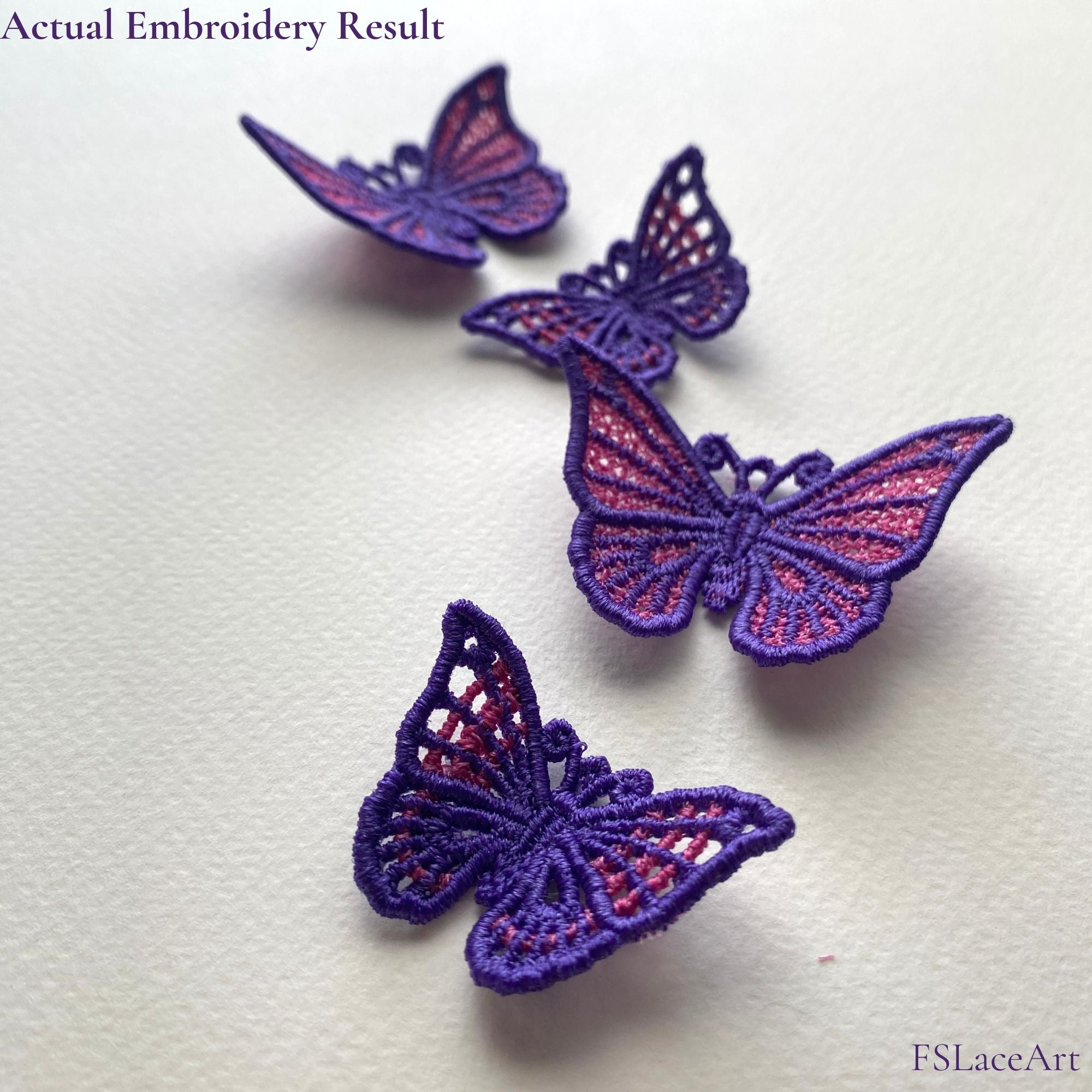 Finished purple and pink butterfly FSL stitch-outs displayed with raised lace wings