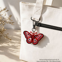 Red spotted butterfly FSL bag charm attached to a white fabric tote with black and silver hardware