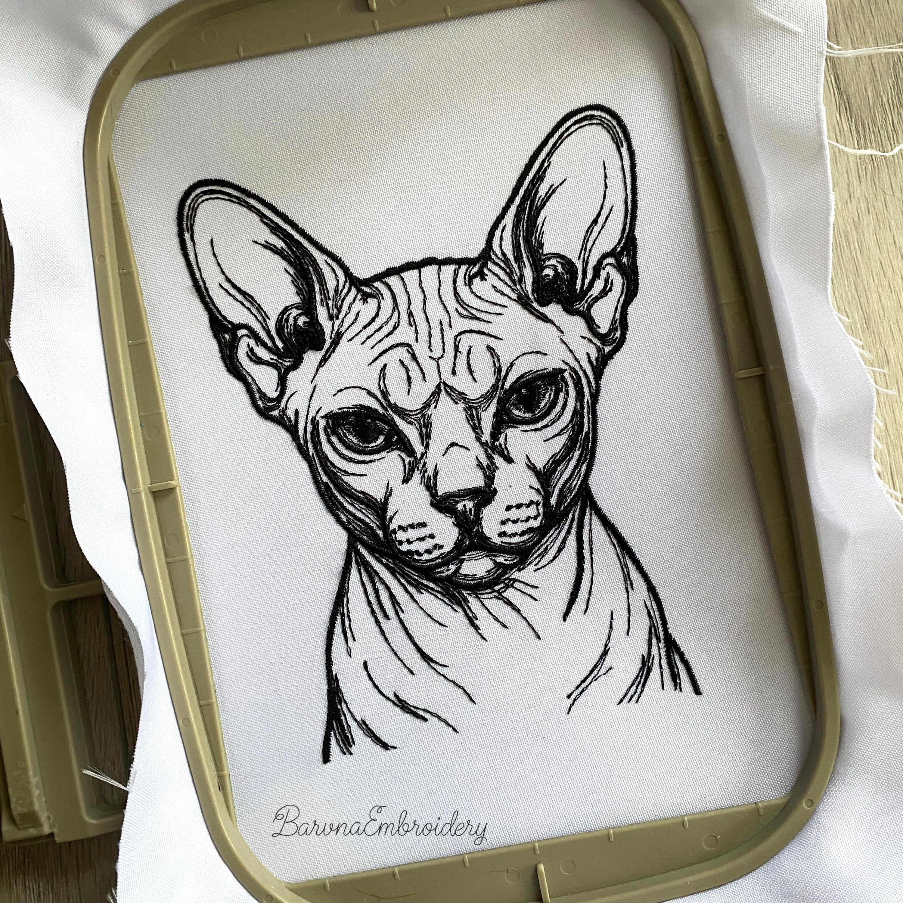 Finished Sphynx cat face embroidery stitched out on fabric in hoop - BarvnaEmbroidery