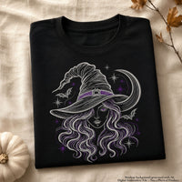 Black shirt mockup featuring witch portrait embroidery with light outlines and purple accents, styled beside a white pumpkin.