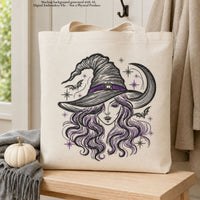 Cream canvas tote bag mockup featuring a witch portrait with dark stitching, purple accents, bats and a crescent moon.